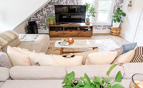 Attic with couch, TV stand and coffee table