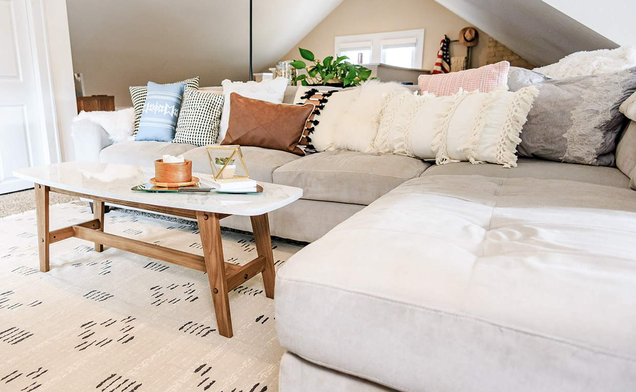 Attic with couch, table and rug