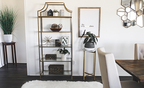 Gold metal and glass tower bookcase in dining room