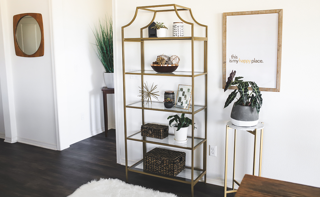 Gold metal and glass tower bookcase in dining room