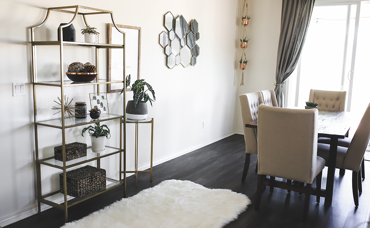 Gold metal and glass tower bookcase in dining room