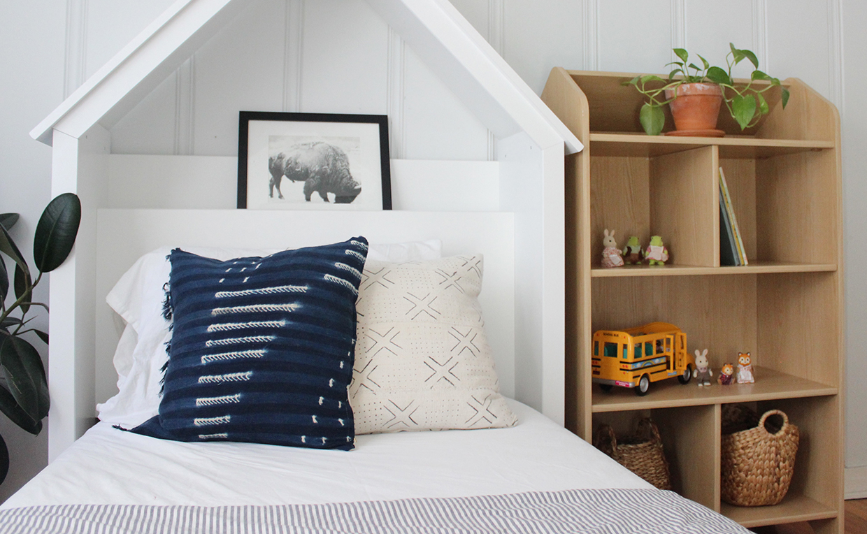 Dollhouse bookcase storage, white twin headboard, kids’ bedroom