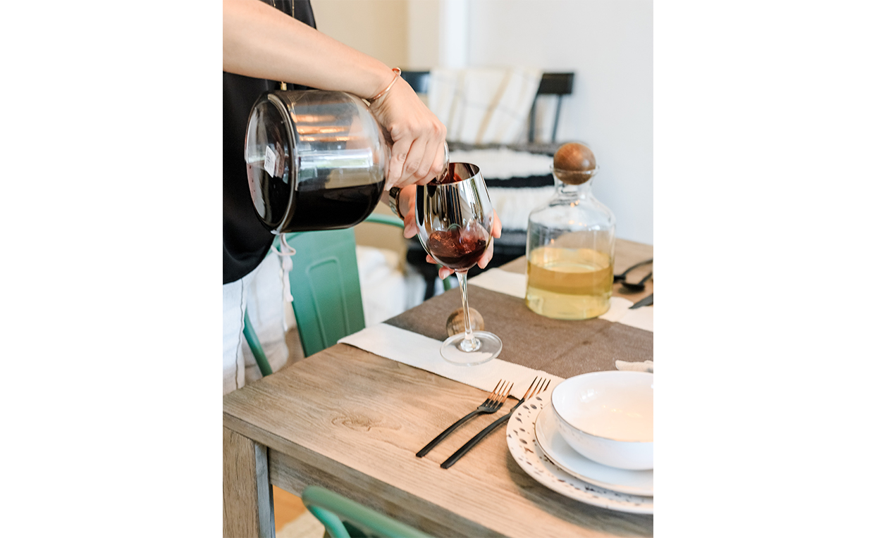 Wine glass, green chair, dining chair, wood table, tableware, dinner party